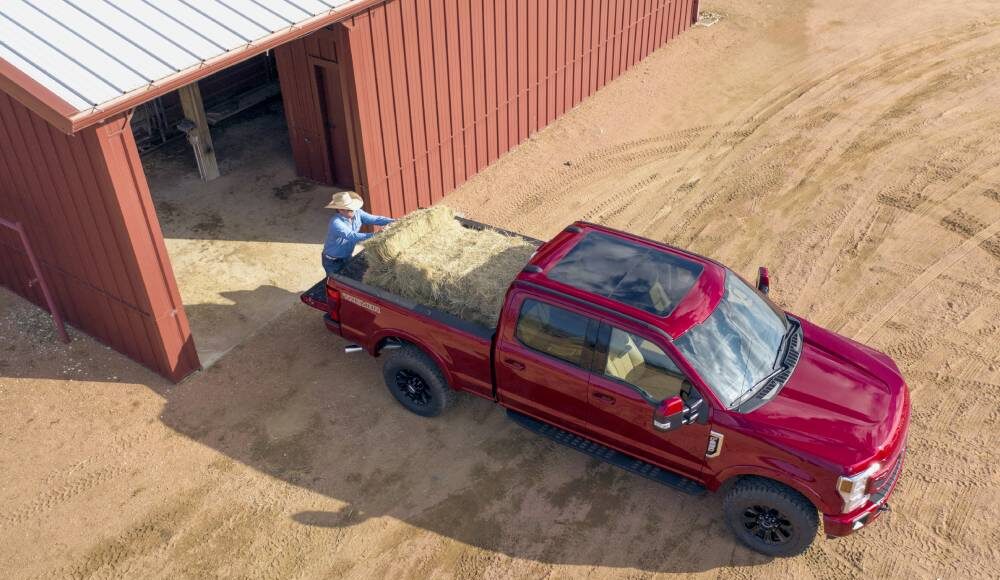 2022 Ford F-250 Super Duty truck with hay being loaded in the bed