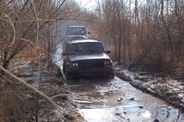 two 4x4s in a river with
