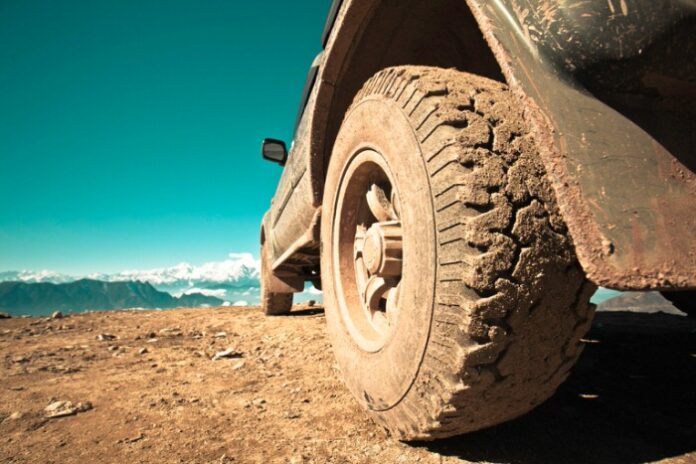 close up of a dirt covered tire of and off-roading 4x4