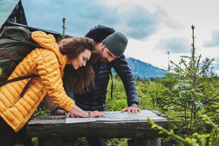 Woman and man looking at map in the forest
