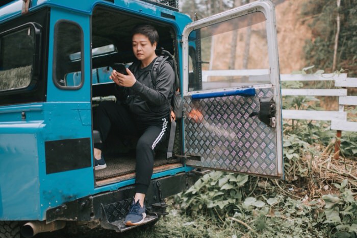 Person using a mobile phone while off-roading