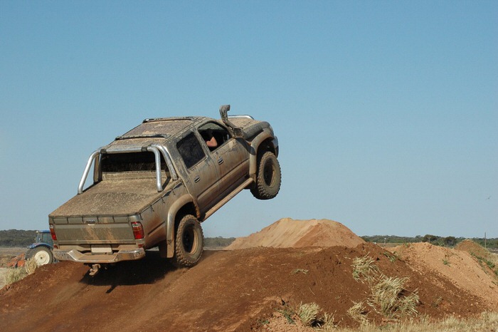 4x4 truck getting air over on a hill