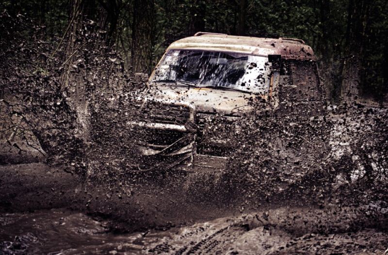 SUV driving though mud with mud terrain tires 