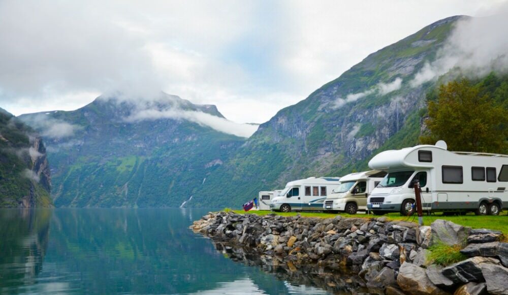 RVs parked by a river on a Luxurious Overlanding Trip