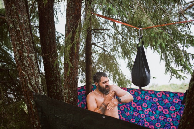 Man Staying Clean When Out Camping by using a pocket shower
