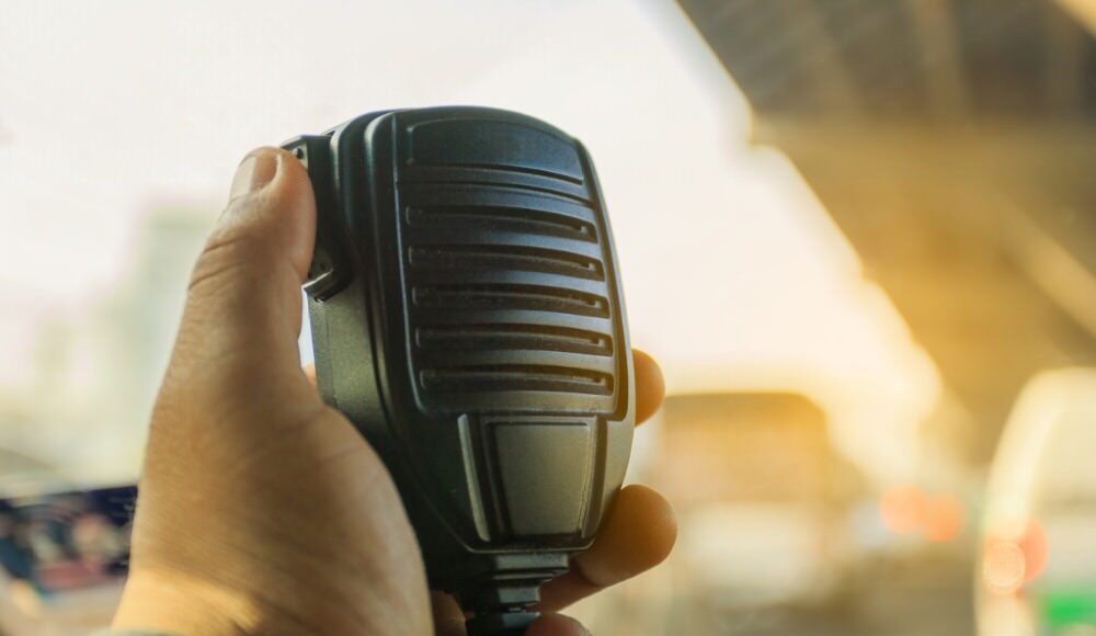 close up of hand using a CB radio microphone