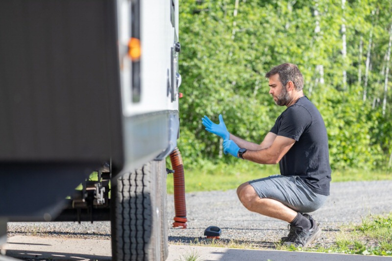 Man preparing to open the water system after sanitizing his camper
