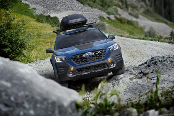 Subaru with roof rack on a rocky slope