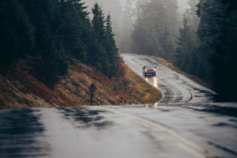SUV driving in the rain on a mountain road