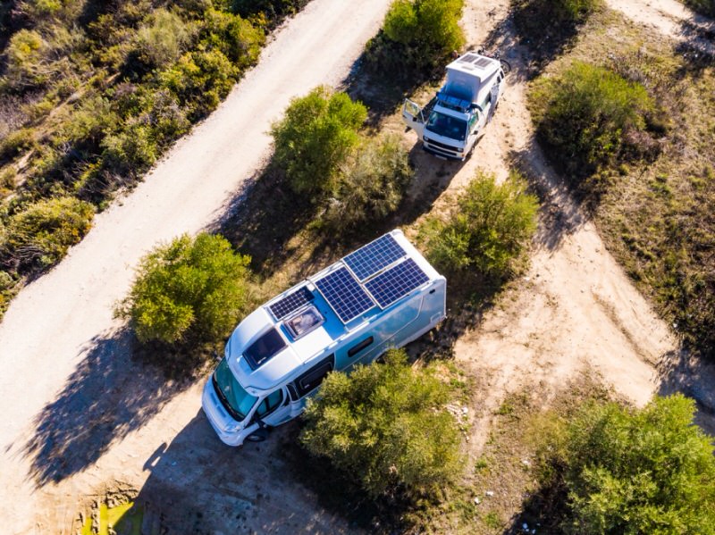 Two campers in the desert with solar panels