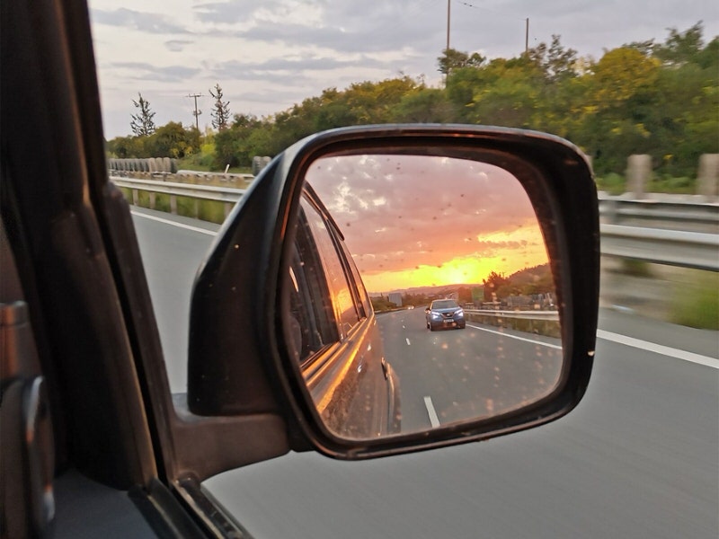 rearview mirror with sunset relected