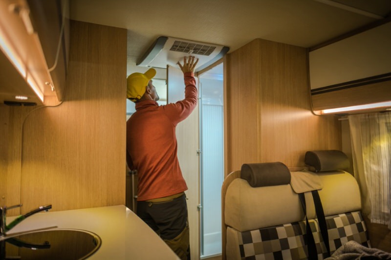 Man Fixing vent in Travel Trailer