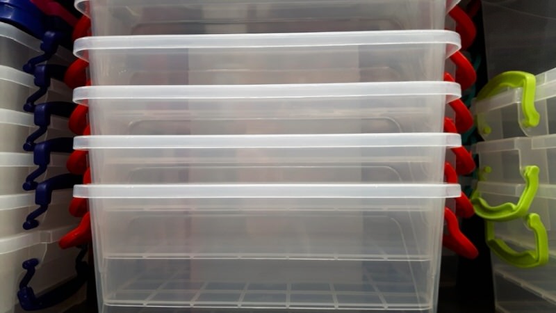 neatly stacked empty, clear plastic storage bins