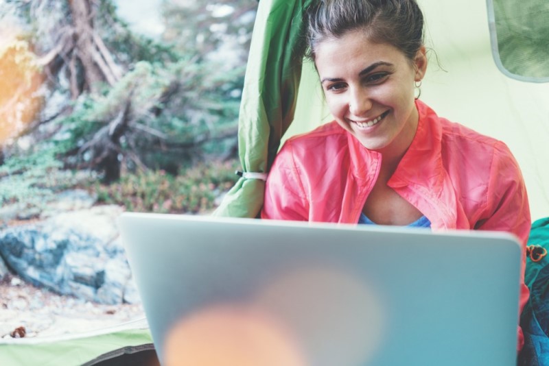woman writing a blog on a laptop