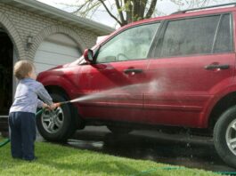 Child washing an SUV