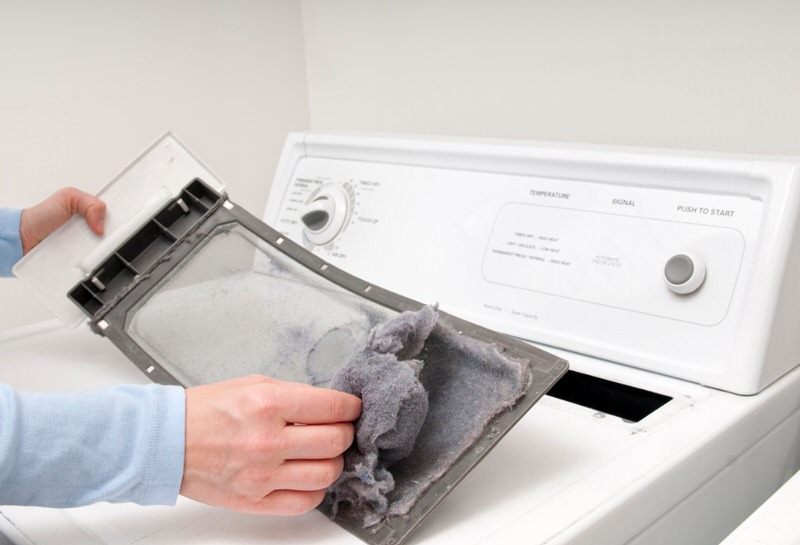 person cleaning dryer lint to save as a RV hack