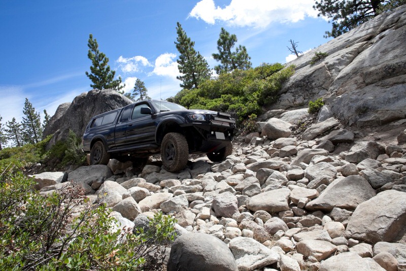 SUV driving over rocks