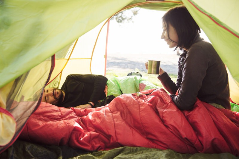 Couple in a tent enjoying the morning