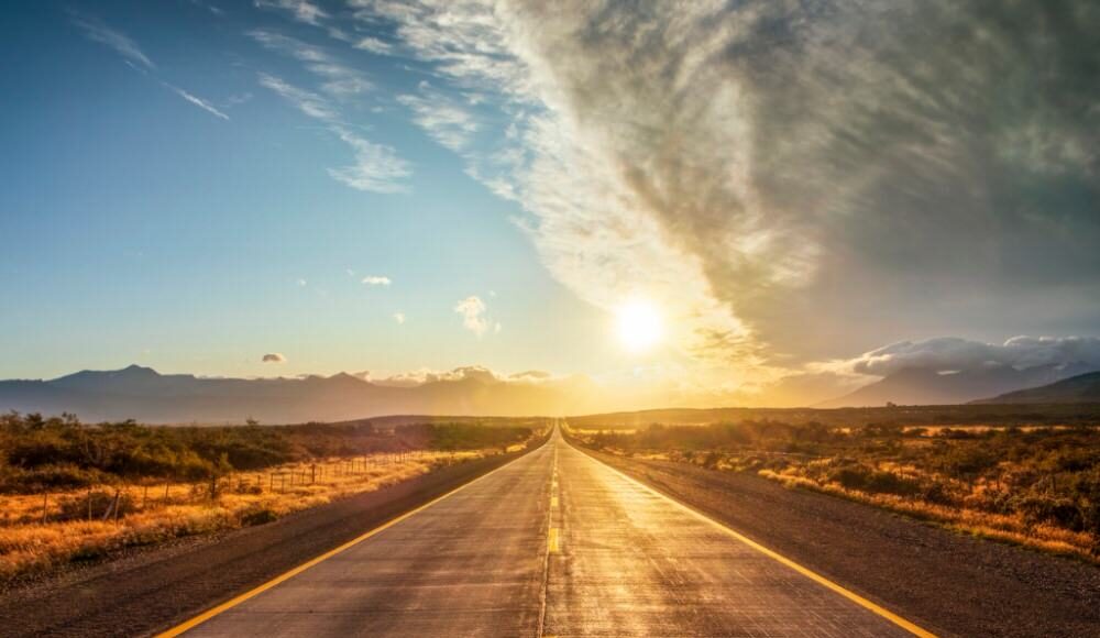 road in the desert at sunset