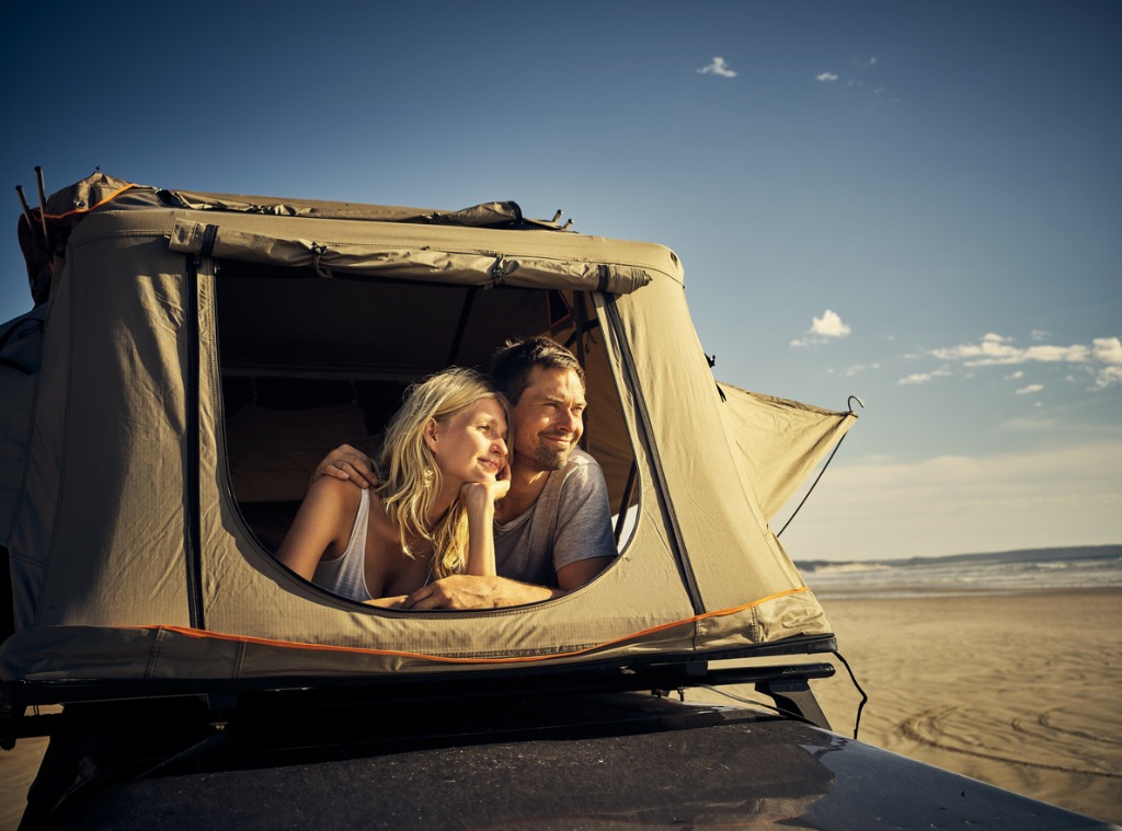 Two people in a roof top camper