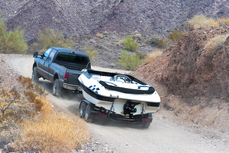 Truck off-road towing a boat