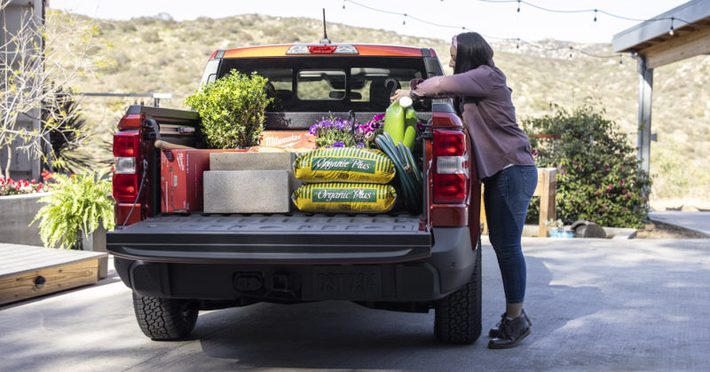 Woman unloading plants from a truck bed