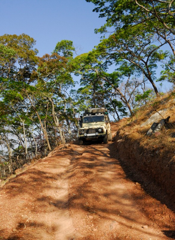 SUV driving down a steep dirt road