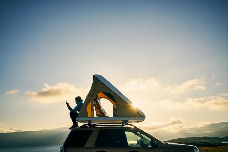 Person reading in a roof top camper