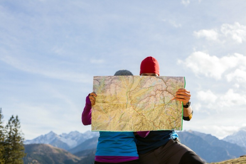 two people planning an overlanding trip with a map