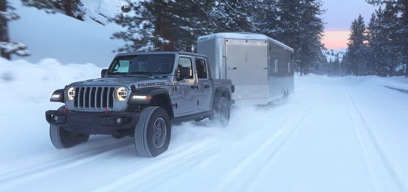 Jeep Gladiator towing a trailer in the snow