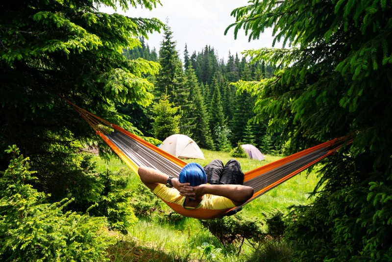 Man relaxing in a hammock while camping