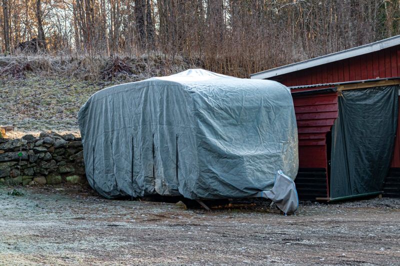 Covered camper in storage