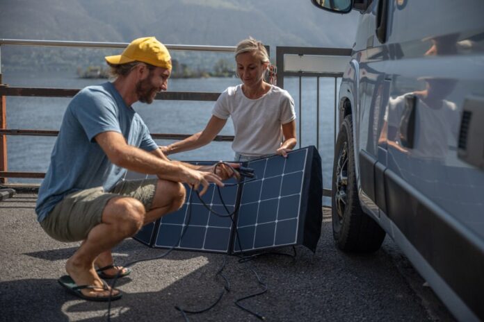 Two people installing a solar panel