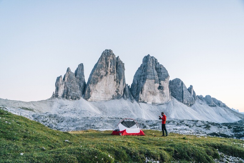Man camping in front of mountians