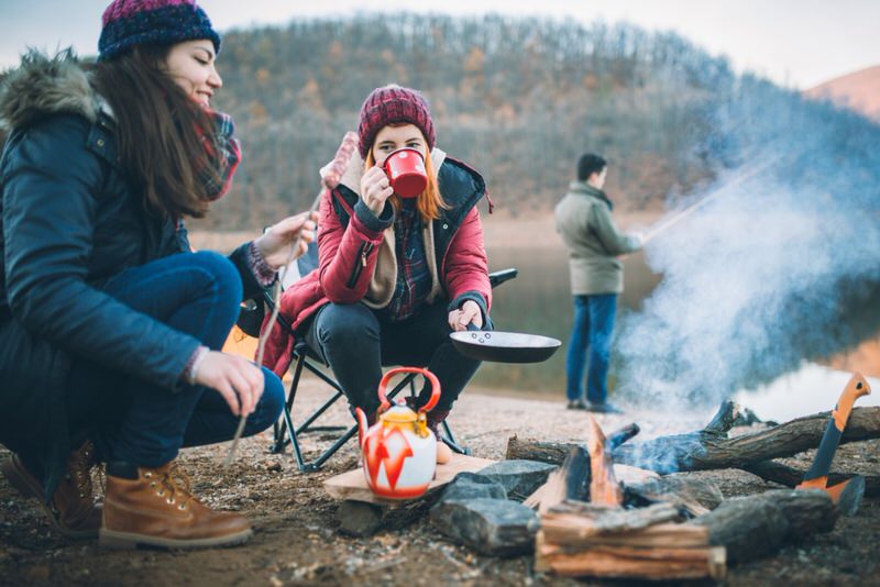 friends eating around a campfire