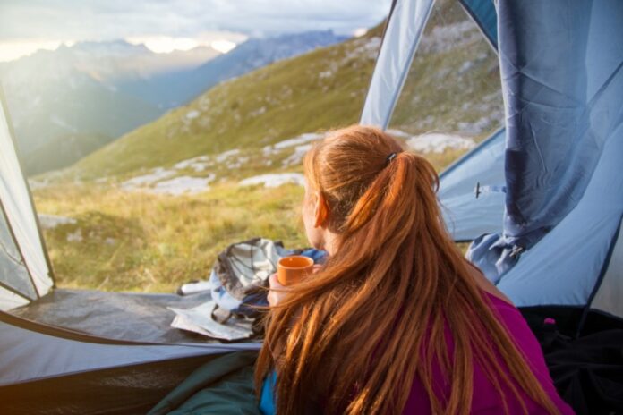 Woman camping in the mountains