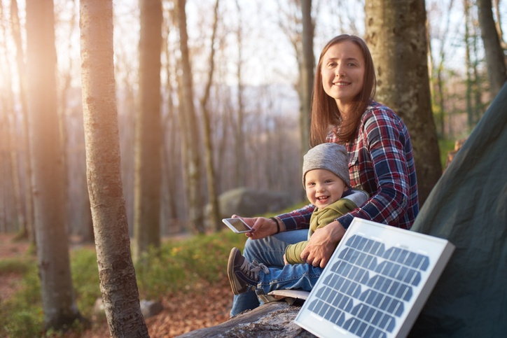 Mother and child camping with a solar panel