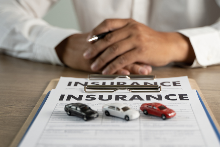 Insurance papers with toy cars