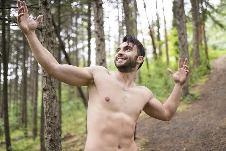 Shirtless young man in the forest