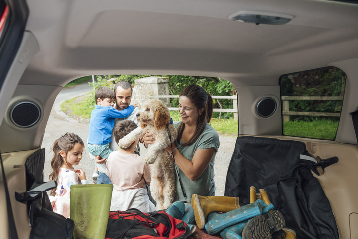 family loading a car for camping