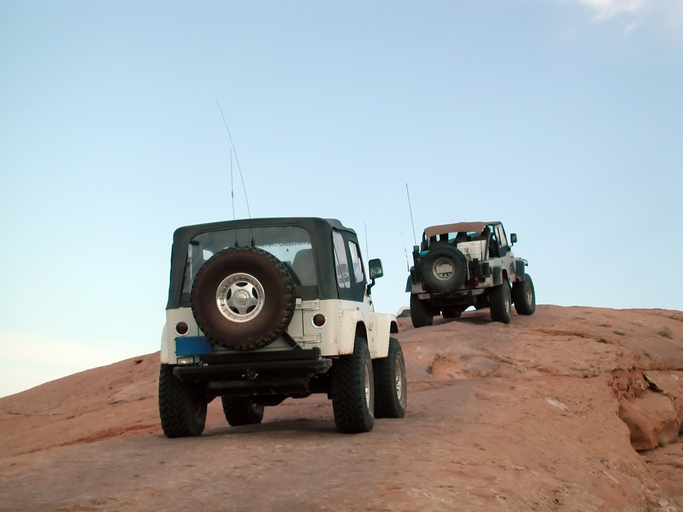 two jeeps on a rocky road - Can You Drive in 4 High All the Time?