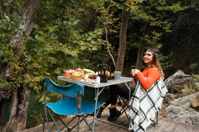 Woman at a camping table
