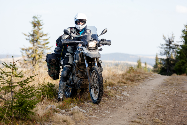 Motorbiker travelling in autumn mountains