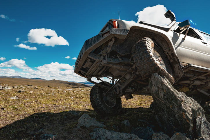 4x4 offroad car stands on big rock