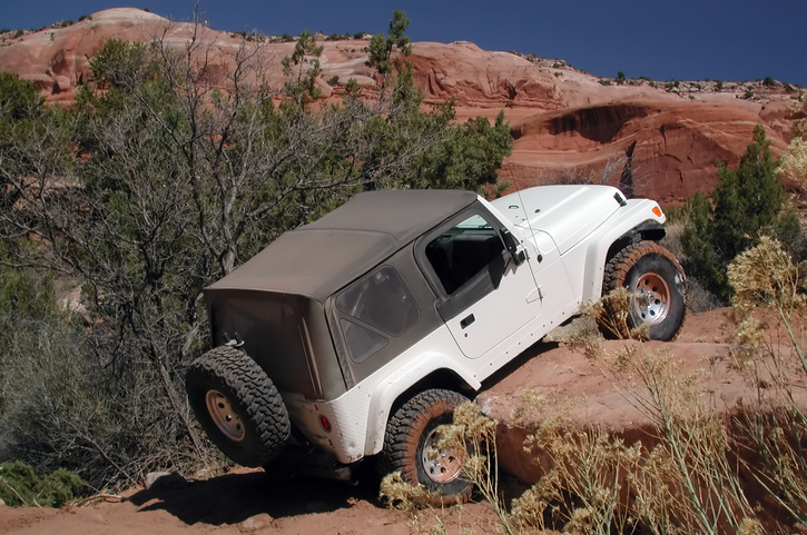Jeep rock crawling on red rock