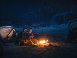 Happy Couple Camping in the Canyon at Night