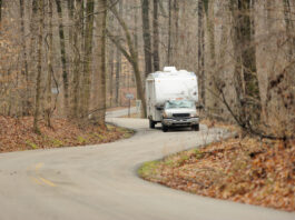 Travel trailer on winding road in woods