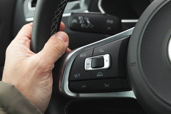 Cruise control and volume buttons on modern car steering wheel