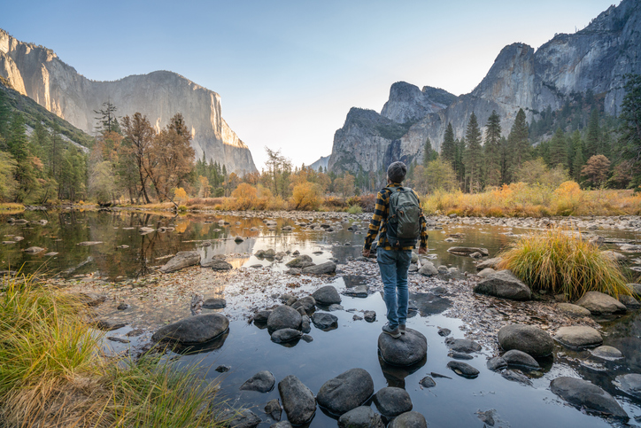 Young man contemplating Yosemite valley from the river, USA