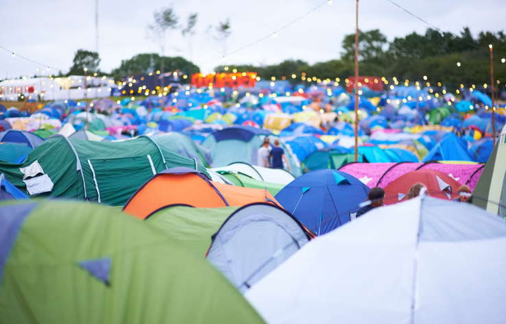 campsite filled with many colorful tents 